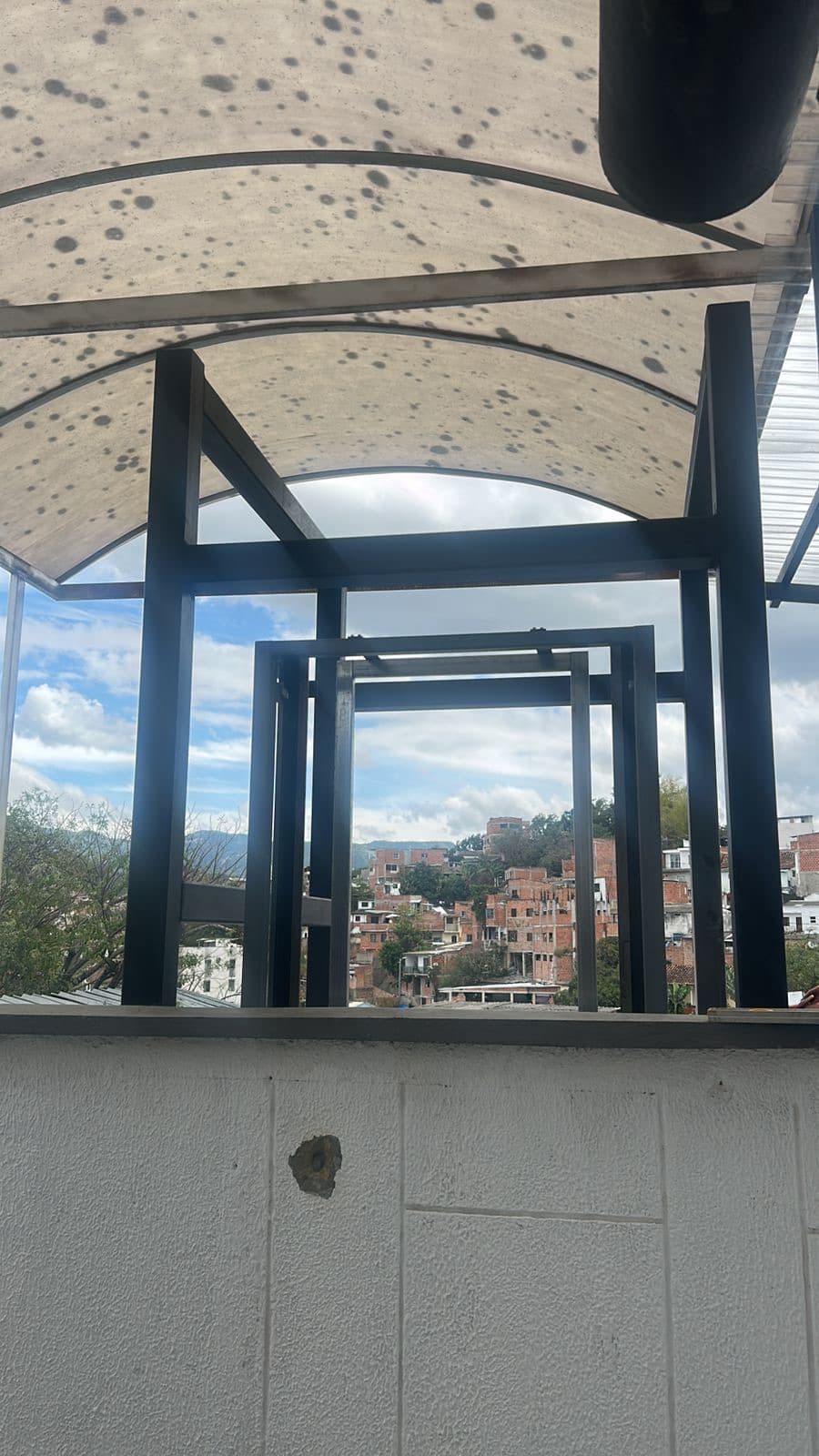 Estructura del elevador hidráulico vista desde la cubierta con el paisaje urbano de Ocaña al fondo